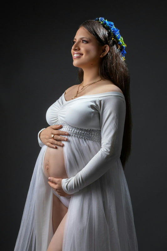 Pregnant woman smiles in her maternity shoot.